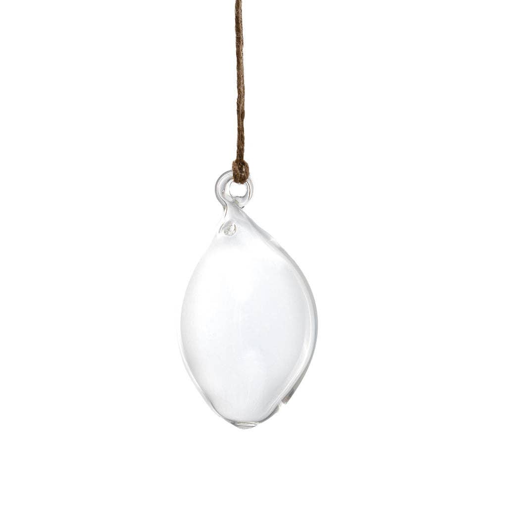 A clear teardrop-shaped glass pendant suspended from a thin brown string against a plain white background.