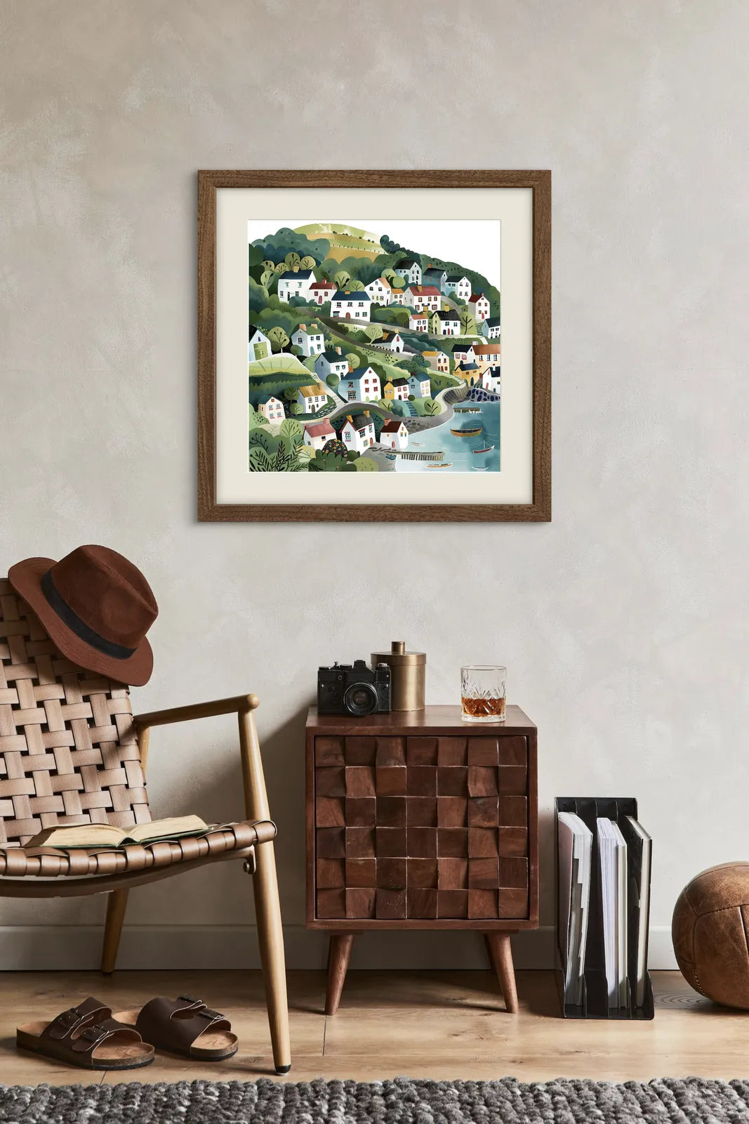 Colourful illustration of a coastal village on green hills with trees and boats.