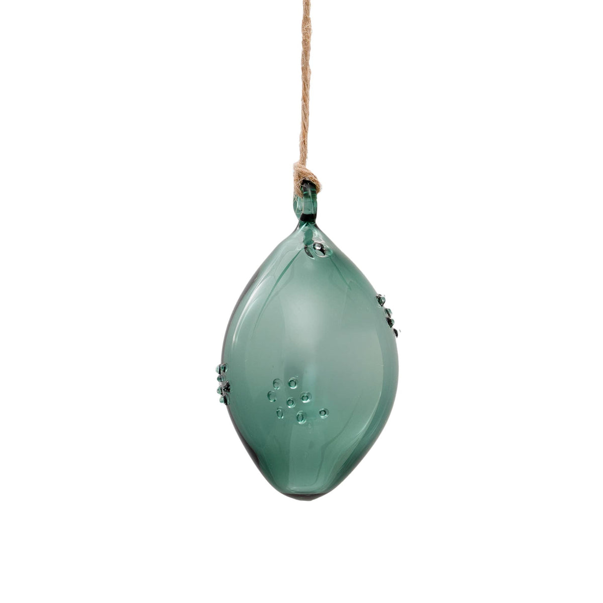 A translucent green glass ornament shaped like a teardrop or leaf, hanging from a natural jute twine string against a solid white background.