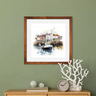 Watercolour artwork of a coastal village with cottages and boats in a harbour.