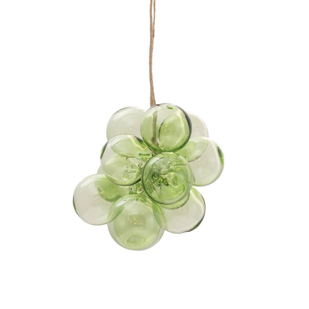 A green glass grape cluster hanging ornament suspended by a natural jute string against a solid white background.