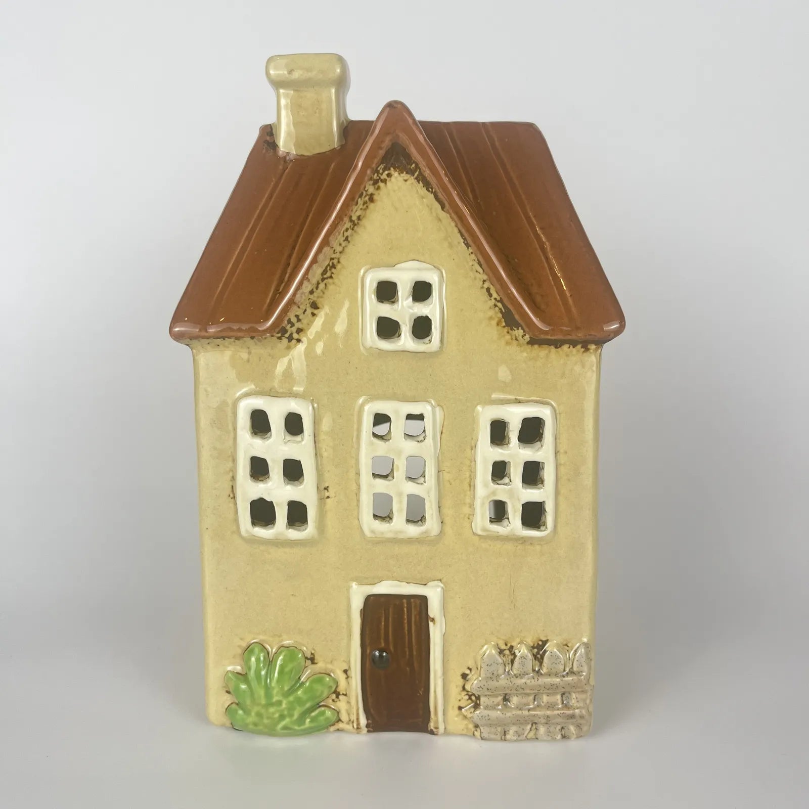 Yellow Ceramic Tealight House with Brown Roof and Green Foliage