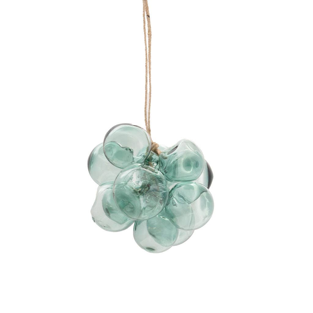 A light green glass grape cluster hanging ornament suspended from a natural jute string against a solid white background.